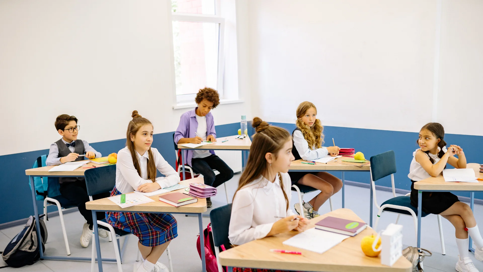 Students in Classroom sitting on chairs doing study activity